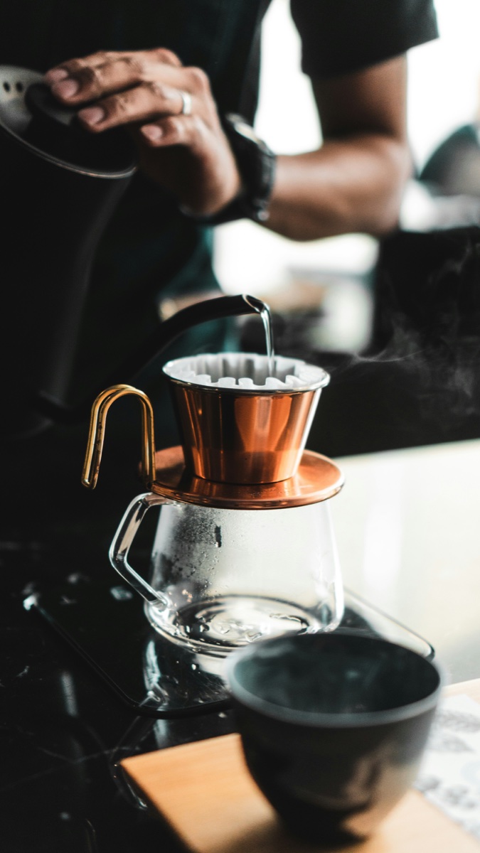 Barista pouring a filter coffee at an Oslo specialty café
