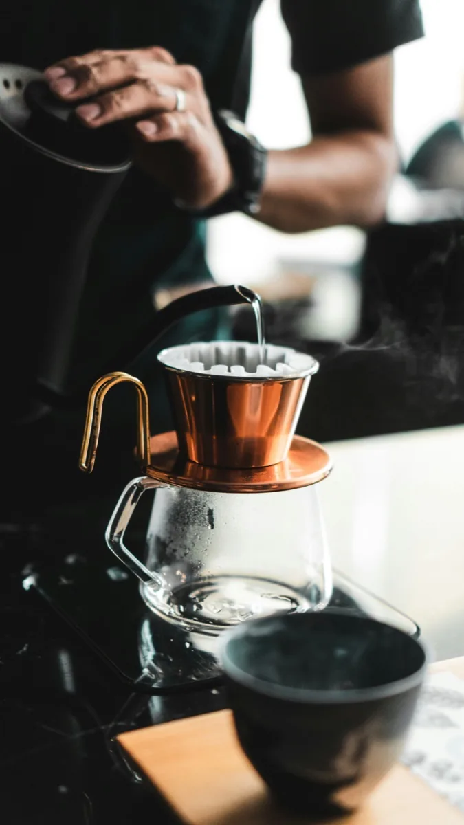 Barista pouring a filter coffee at an Oslo specialty café