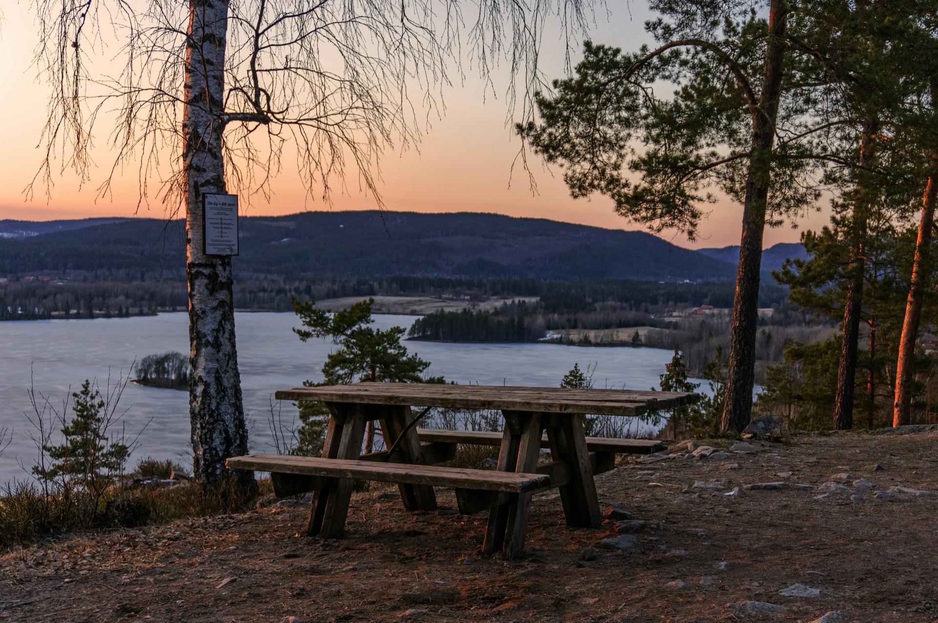 Forest lake at sunset viewed from a rest stop in the Nordmarka forest outside Oslo