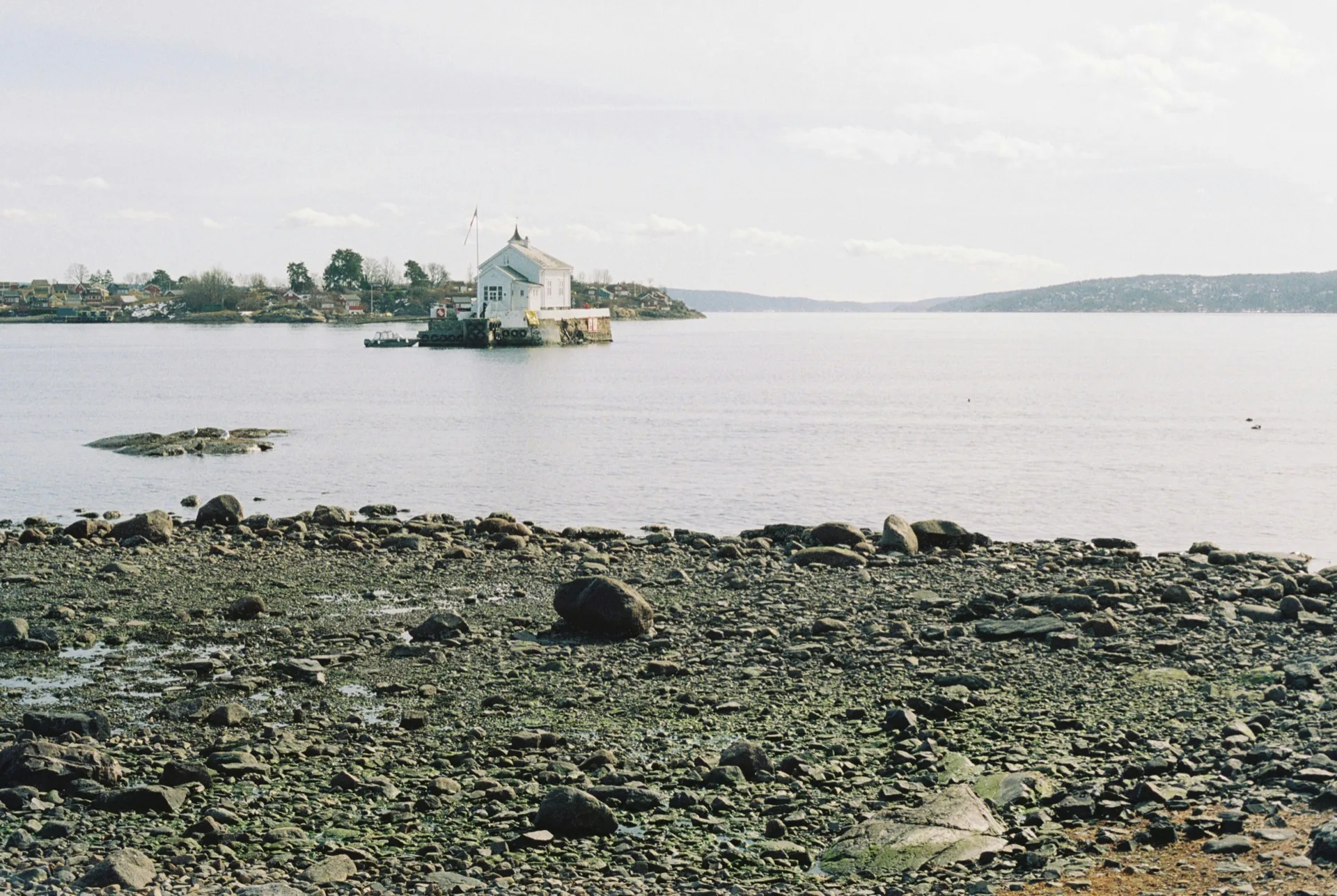 White boathouse on a small island in the Oslofjord
